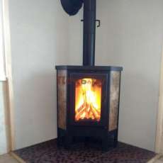 Недорогая печь-камин Бавария Эко угловая с плитой одна конфорка фото в интерьере в Лиде