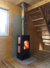 Популярный камин с дровницей Сибирь 8 в интерьере фото в Лиде